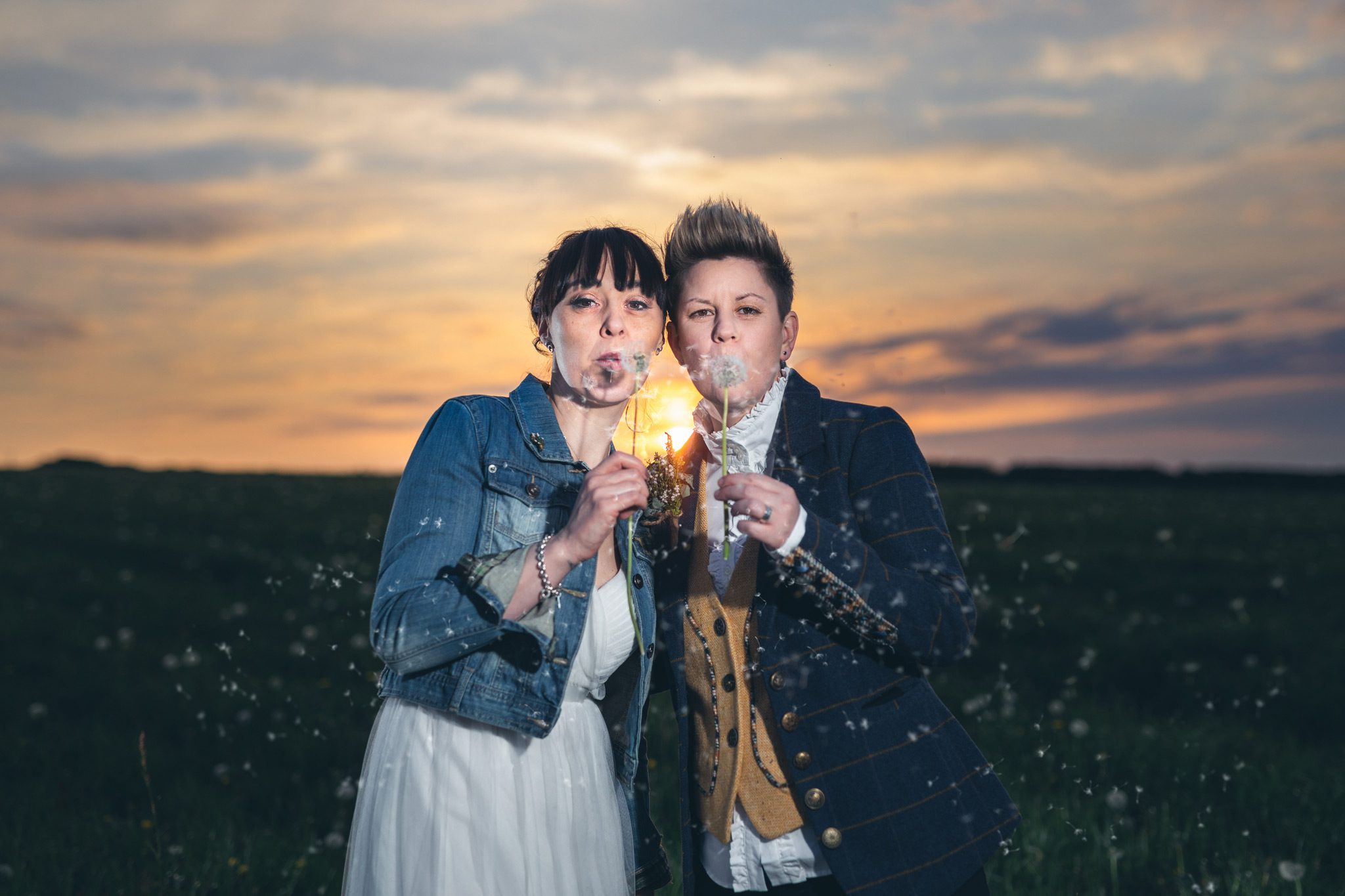 The couple blowing dandelion seeds