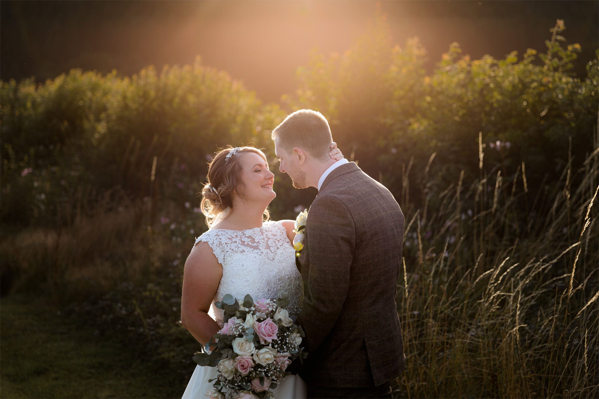 Golden light behind bride and groom