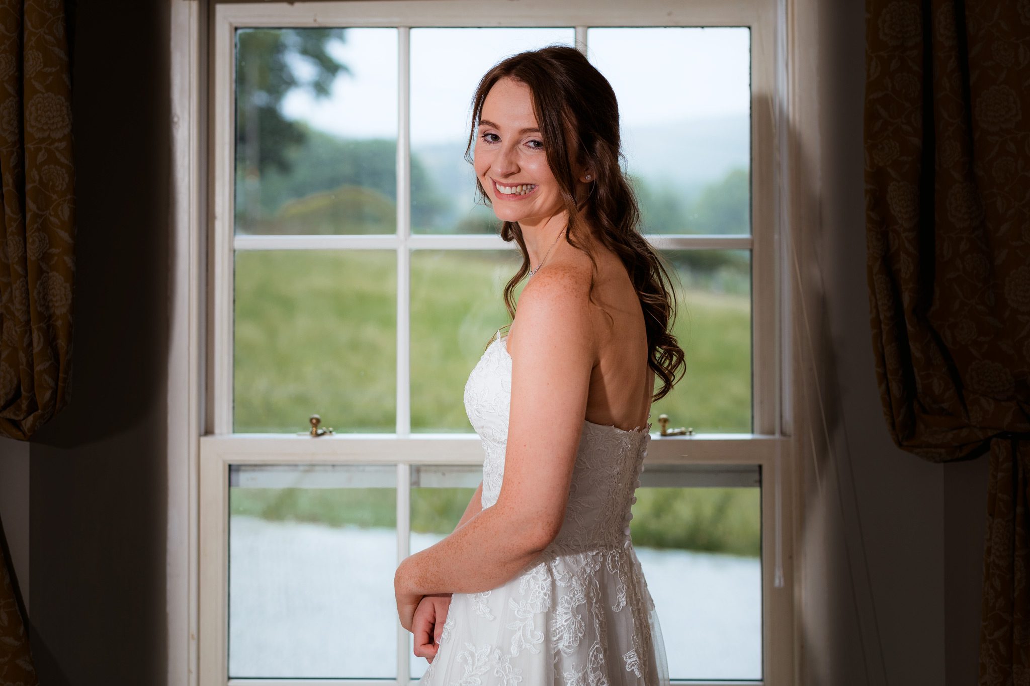 The bride posing for portraits at Losehill House.