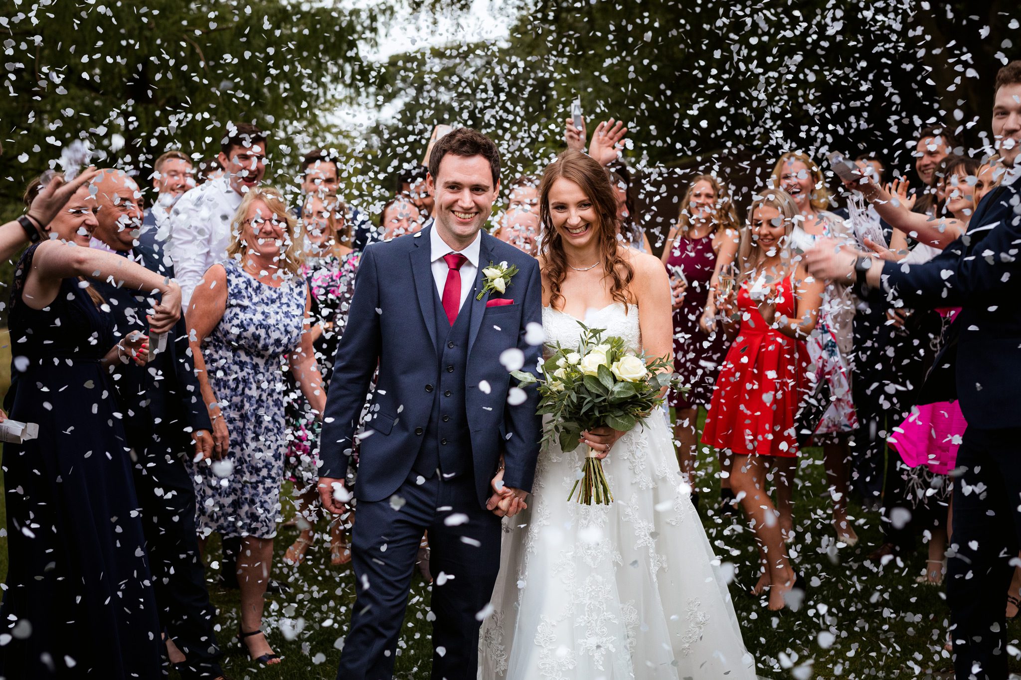 Amazing Confetti Throw at Losehill House. Sarah and Ryan's guests throwing huge amounts of confetti over them.